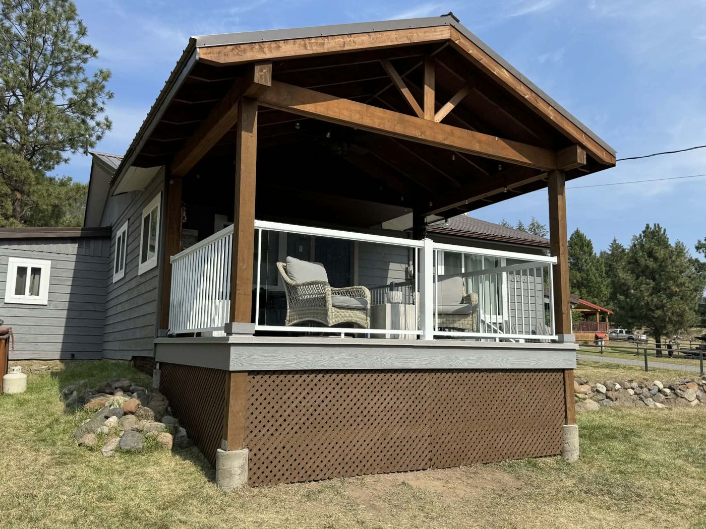 Covered deck with timber-framed roof built by Sunnyside Carpentry